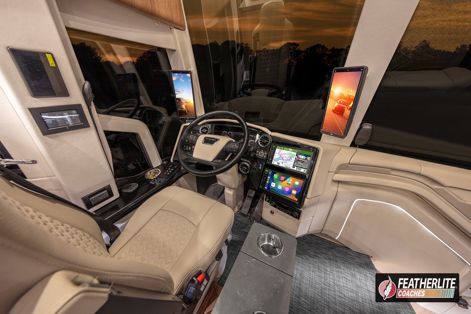Featherlite Durango cockpit with ergonomic dash and premium leather captain chairs | 2026 Featherlite Prevost Luxury Motorhome 